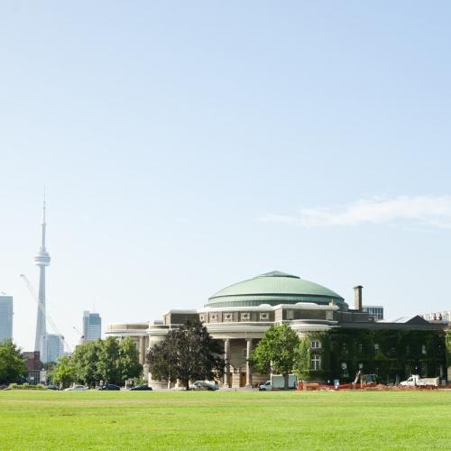 Panoroma photo of Front Campus and Convocation Hall in summer, with CN Tower in the background.