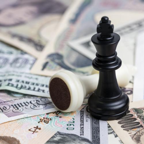 Image of chess pieces on top of different types of currency to illustrate the topic of the panel.
