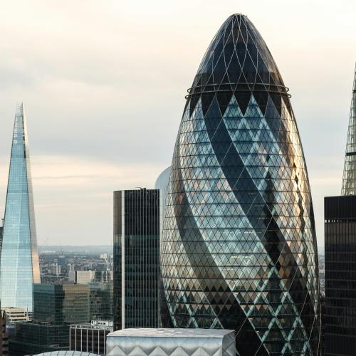 View of London at sunrise. Several corporate buildings are visible including the Gherkin and the Shard